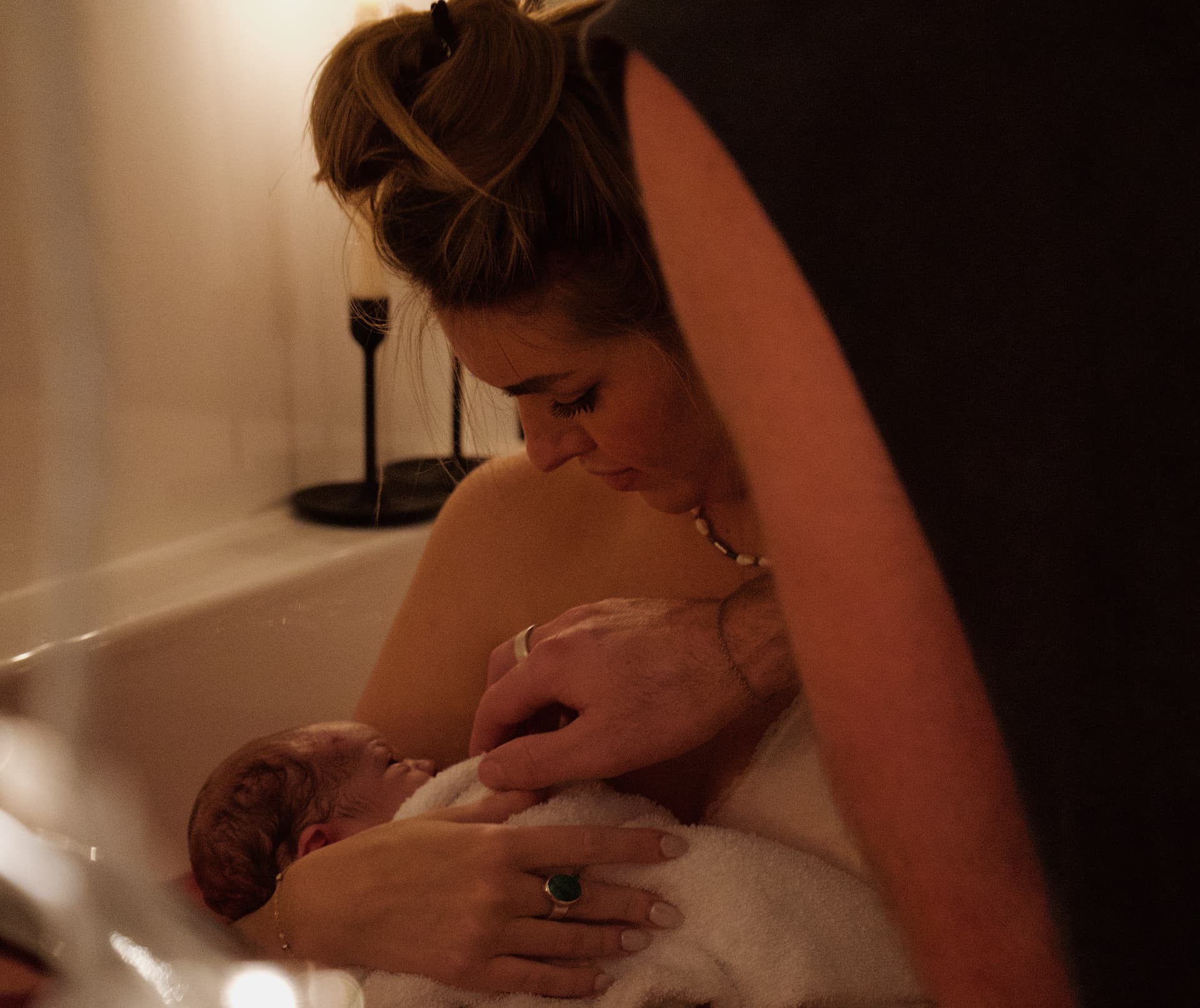 Intimate water birth scene - mother and newborn in peaceful moment