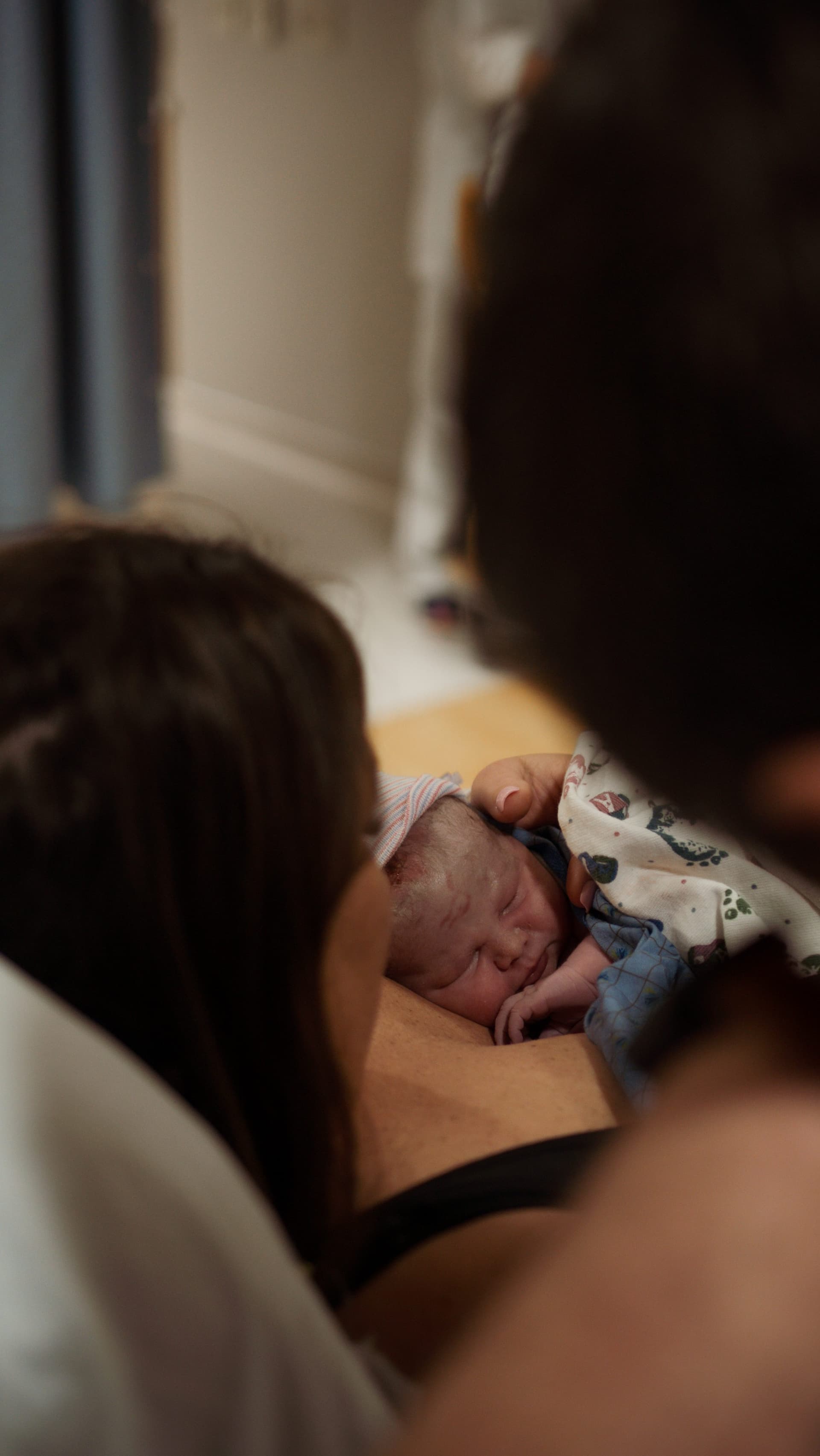 Intimate newborn moment - baby's first embrace